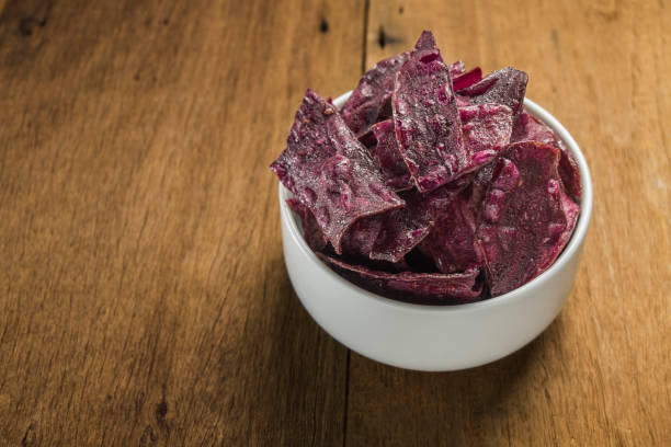 istock Purple sweet potato chips in white ceramic bowl 814997860