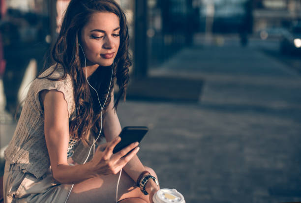 istock Young woman texting in front of building 815000450