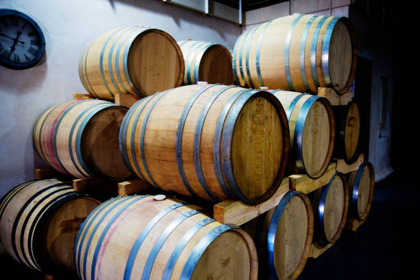 istock Wine barrels stacked in a winery 815000938
