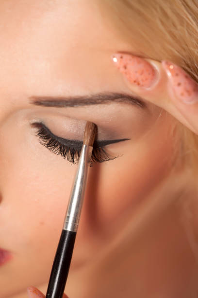 istock closeup of applying eye shadow with a brush 815001748