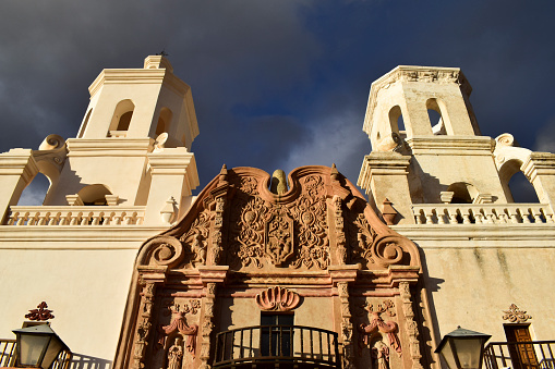 Exterior of Mission San Xavier del Bac against moody sky, Arizona