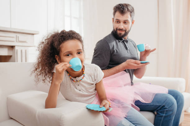 istock multicultural family drinking tea while having tea party at home 815005482