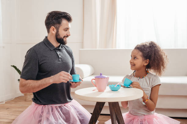 istock multicultural father and little daughter having tea party at home 815005616
