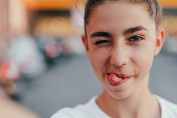 Teenager girl make selfie and making grimaces