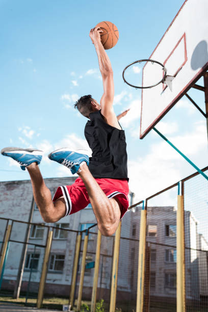 istock back view of basketball player throwing ball into basket during game 815008738