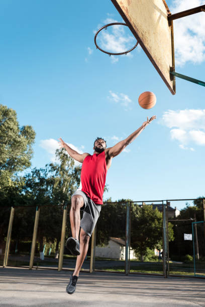 istock african american basketball player throwing ball into basket during game 815008792
