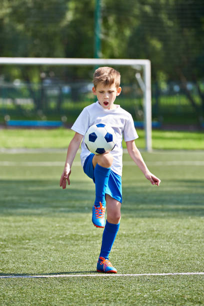 istock Boy soccer playing with ball 815012024