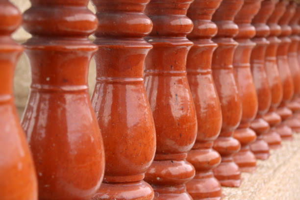 Row of red brown ceramic balustrades.