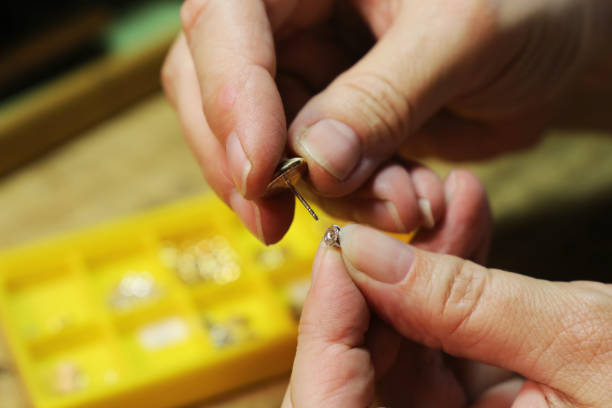 istock Female goldsmith repairing an earring 815012280