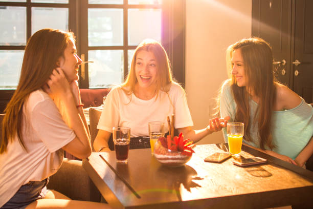 istock Young women talking and having fun in cafe. 815014782