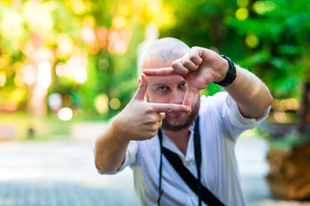 istock Young male photographer framing a shot using his fingers 815025718