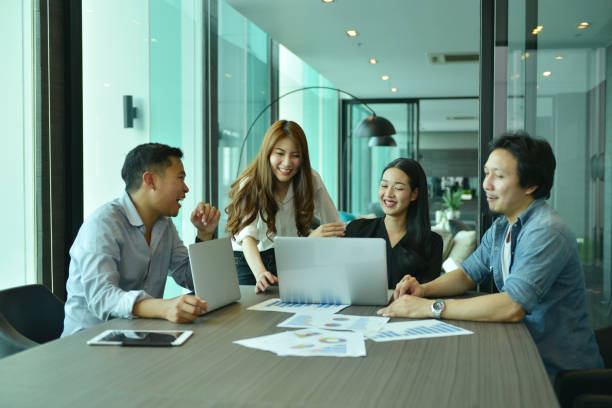 istock Teamwork of Asian business people succeed a project, tag team 815026190