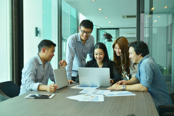 istock Teamwork of Asian business people succeed a project, tag team 815027698