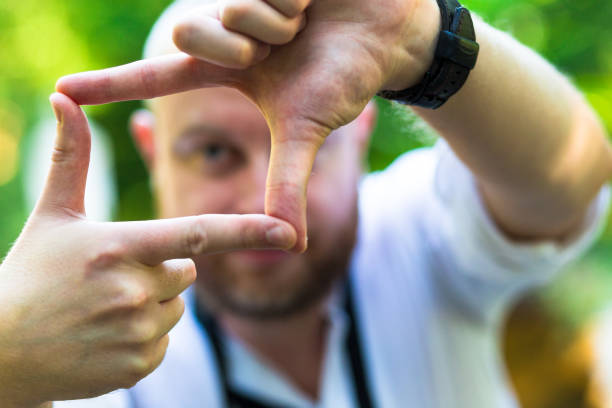 istock Young male photographer framing a shot using his fingers 815031836
