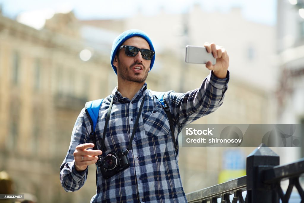 Tourist making selfie Young man making selfie while having walk in the city Adult Stock Photo