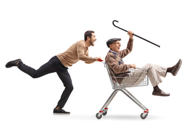 istock Young guy pushing a shopping cart with a senior inside 815042572