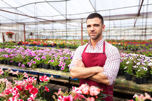 istock Greenhouse worker standing arms crossed 815043064