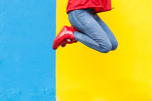 pair of pink and orange sporty shoes for kid on red background