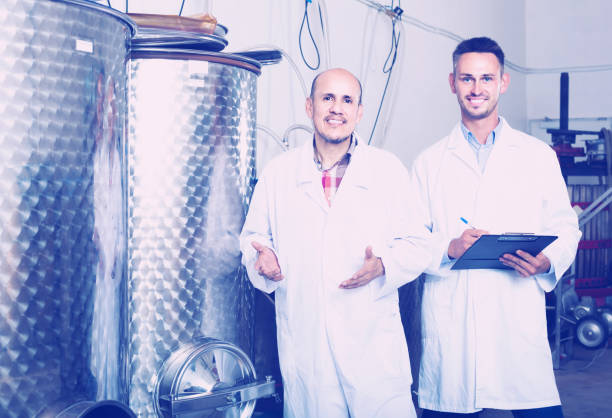 istock two men coworkers in white coats working in fermentation section 815054924