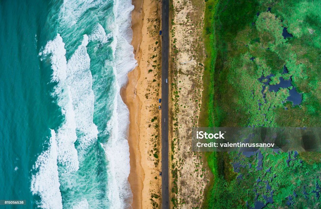 Sea waves, beach and road Aerial view of sea waves and beach, country road. Aerial View Stock Photo