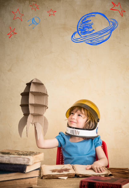 istock Child playing with cardboard toy rocket 815059576