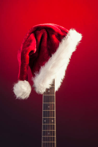 istock Red Christmas hat on guitar 815063140
