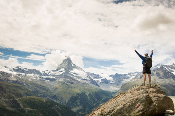 istock Success - male hiker stands on a rock 815069290