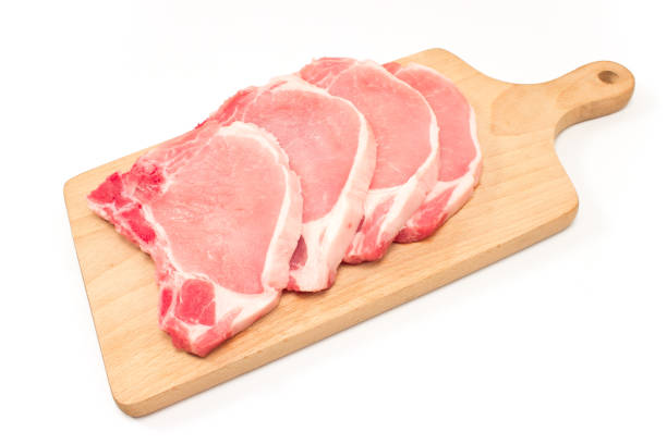 istock Raw pork chop meat on cutting board isolated on white 815074284