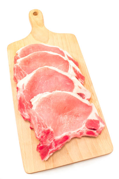 istock Raw pork chop meat on cutting board isolated on white 815074592
