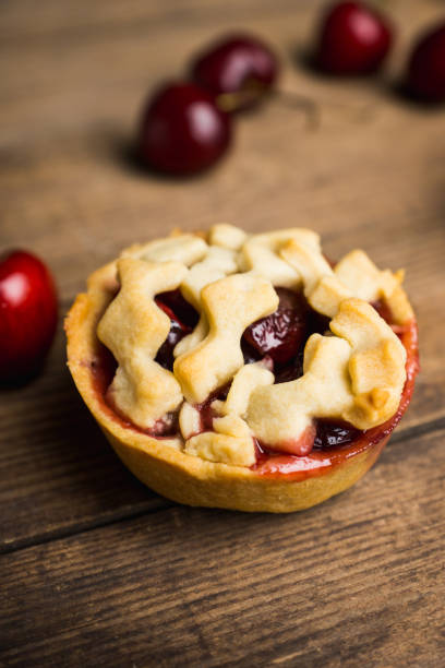 istock Delicious cherry tartlets on the rustic background 815081578