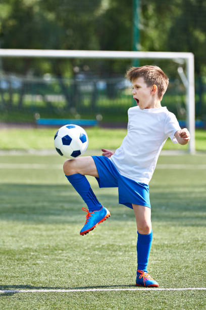 istock Boy soccer playing with ball 815082170