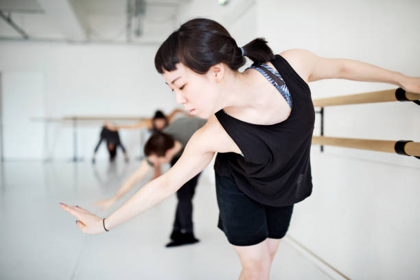 istock Young female dancer performing ballet at barre 815114374