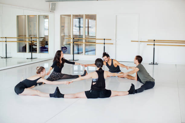 ballet dancers doing stretching exercise in circle - round bale imagens e fotografias de stock