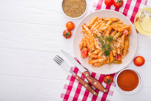 istock delicious penne pasta on wood white table 815161660