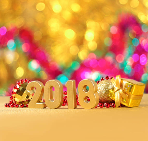 istock 2018 year golden figures on a bokeh background 815163210