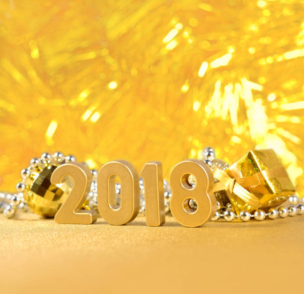 istock 2018 year golden figures on a bokeh background 815165624