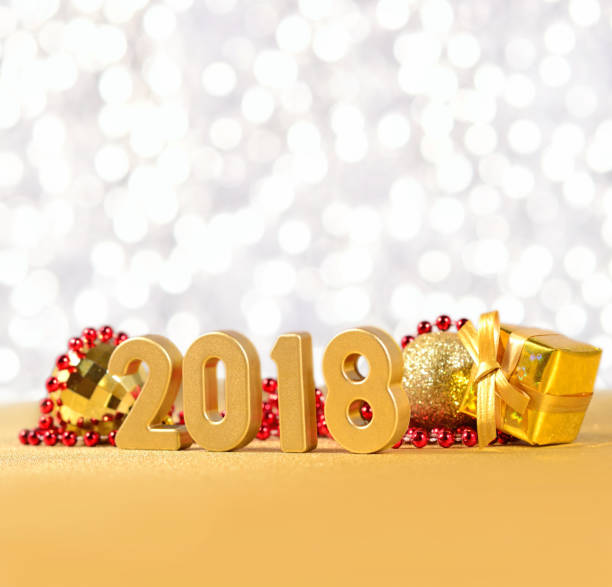 istock 2018 year golden figures on a bokeh background 815165758
