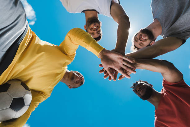 istock Bottom view of multiethnic soccer team holding hands together before game 815166494