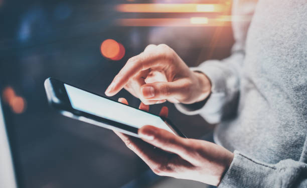 istock Female finger pointing on screen smartphone on background illumination glow bokeh light in night atmospheric.Horizontal, blurred background, flares. 815166538