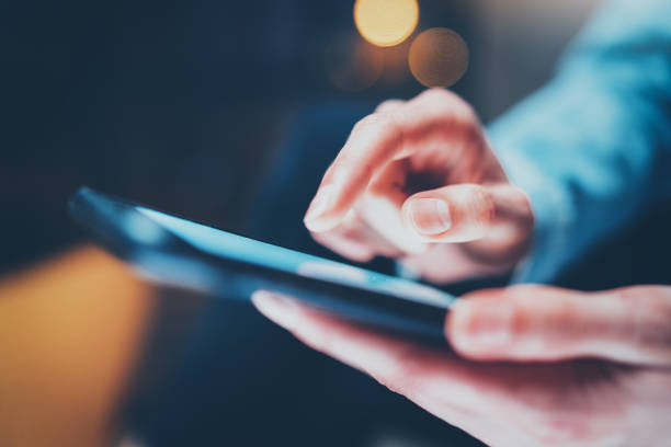 istock Closeup view of female hands touching smartphone white blank screen.Horizontal, blurred background, bokeh effects. 815166664