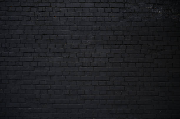 istock Horizontal part of a black painted brick wall, texture. 815169470