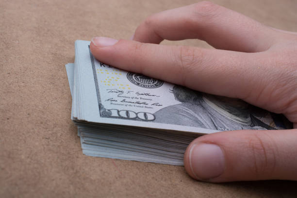 istock Hand holding banknote bundle of US dollar in hand 815169734