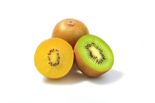 Ripe whole green and gold kiwi fruit and half kiwi fruit on white background.