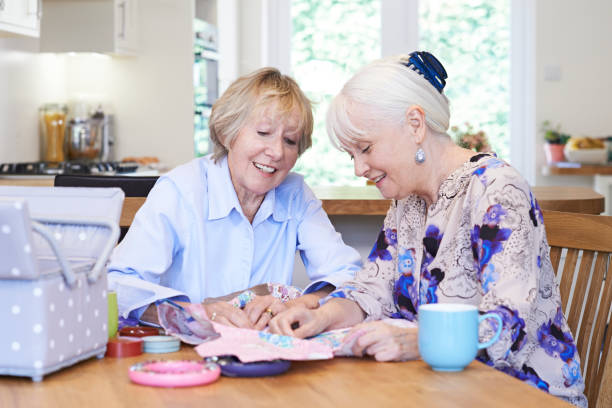 istock Two Senior Women Sewing Quilt Together 815180672