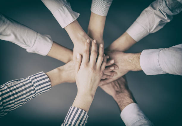 istock Hands stacked in a pile. A symbol of teamwork and trust. 815187524