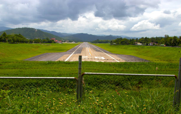 istock plane landing on runway of a small airfield. 815188954