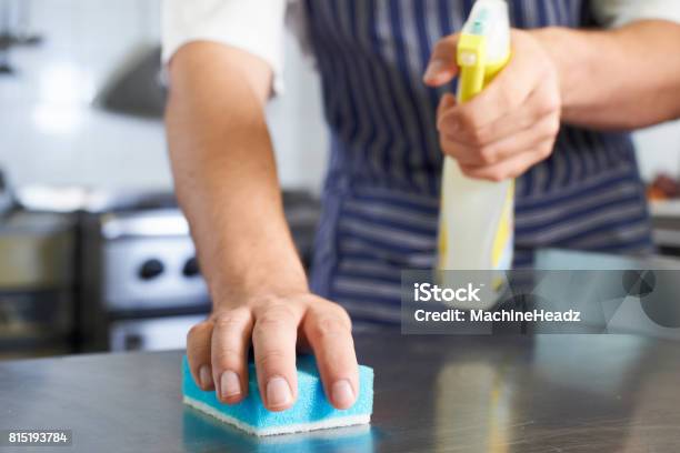Close Up Of Worker In Restaurant Kitchen Cleaning Down After Service Stock Photo - Download Image Now