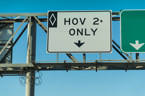 A stock photo of the HOV lane (High Occupancy Vehicle) road sign in California, USA.