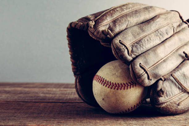 istock old Baseball and glove on wood background with filter effect retro vintage style 815195920