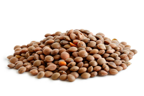istock Heap of unpeeled red lentils isolated on white. 815196622